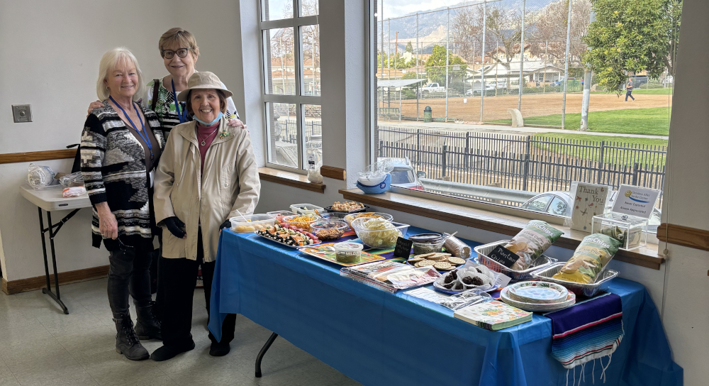 Jodine, Christie, and Elinore pose by their beautiful snack table